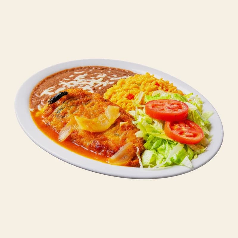 Weekday lunch plate: a chile relleno in ranchero sauce with rice, refried beans, lettuce and tomato